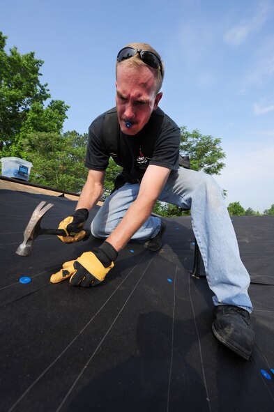 SEYMOUR JOHNSON AIR FORCE BASE, N.C. -- Tech. Sgt. Robert Poll nails roofing paper onto a house being built by the Habitat for Humanity foundation in assistance with Airmen and their families here, May 10, 2011. People who apply for a Habitat for Humanity house must contribute more than 400 hours to the construction or maintenance on their potential house or another house within the Habitat for Humanity community before they are selected for a no-interest loan on a property. Sergeant Poll, 4th Equipment Maintenance Squadron aircraft metals technology assistant NCOIC, hails from Leesville, La. (U.S. Air Force photo/Senior Airman Rae Perry)