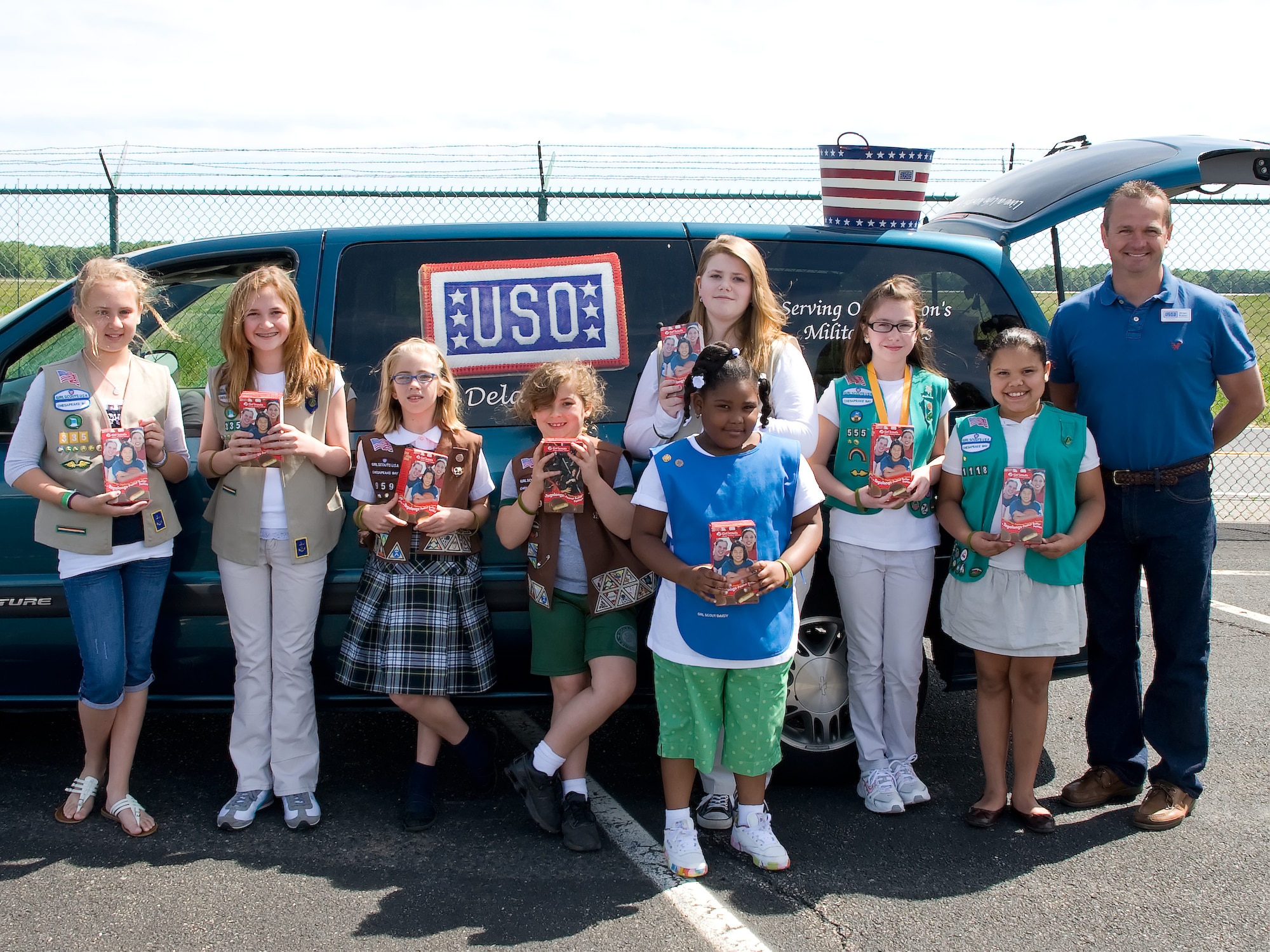 The Chesapeake Bay Girl Scouts pose for a photo after loading cookies for the United Service Organization May 10, 2011, at the Air Mobility Command Museum, Dover, Del. The Girl Scouts donated the cookies to the USO to be distributed to servicemembers. (U.S. Air Force photo by Adrian Rowan)