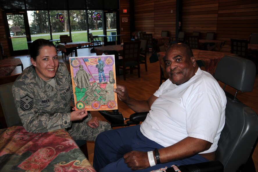 Master Sgt. Elizabeth Riser, first sergeant for the 446th Security Forces Squadron at Joint Base Lewis-McChord, MCChord Field, chats with Mr. Henry Boggs, a Vietnam War veteran who lives at the American Lake Veterans Hospital in Tacoma, Wash. Reservists from the 446th Airlift Wing particpated in the Visit a Vet program on April 30.  (U.S.Air Force photo by 2nd Lt. Denise Hauser)