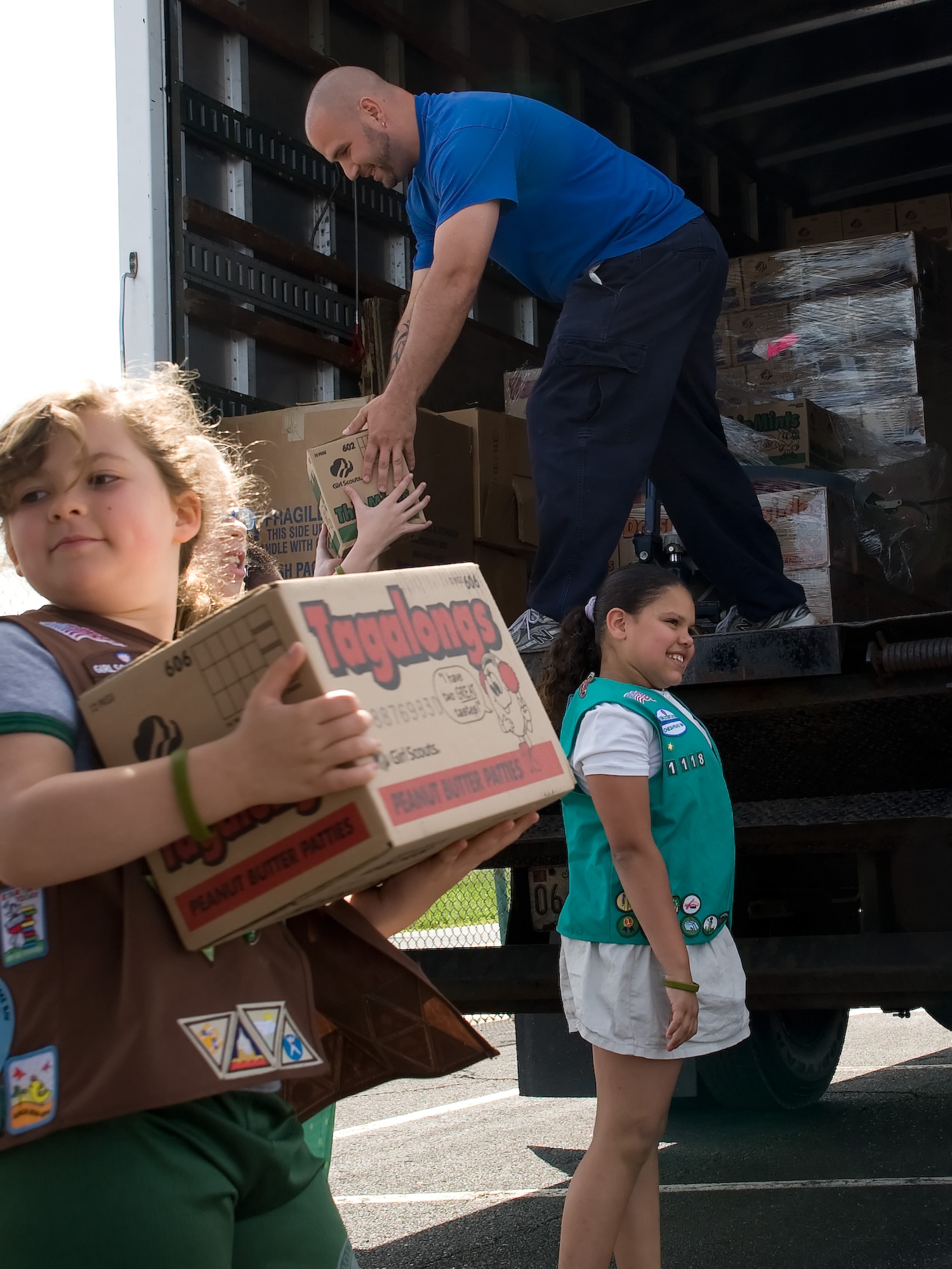 The Chesapeake Bay Girl Scouts load cookies for the United Service Organization May 10, 2011, at the Air Mobility Command Museum, Dover, Del. The USO will be handing out the cookies to deploying and returning servicemembers. The Girl Scouts sold extra cookies to donate 10 percent of boxes sold to servicemembers. (U.S. Air Force photo by Adrian Rowan)