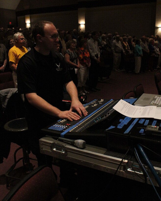 Audio Engineer A1C Brian Lumpkin makes adjustments on the sound board during a concert band performance in the Rio Grande Valley in South Texas.