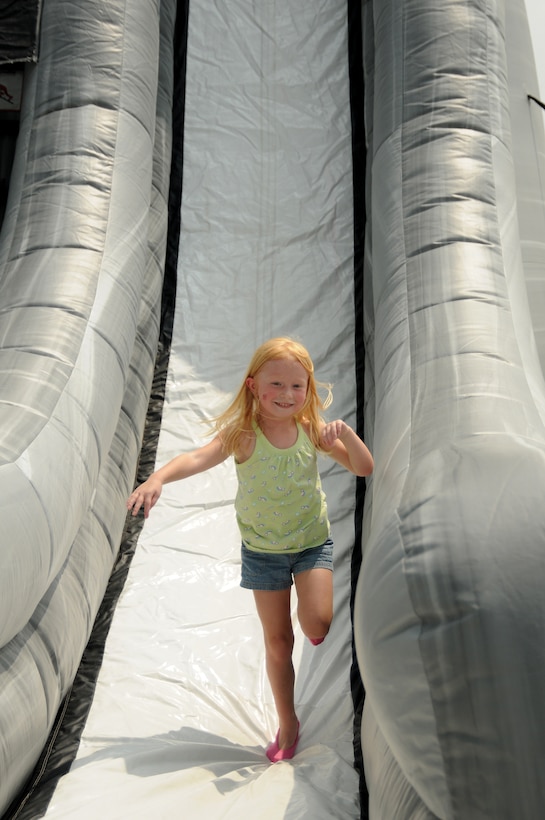 A guest enjoys a romp down an inflatable slide at the Kentucky Air National Guard's Family Day,  held July 17, 2010 in Louisville, Ky.  Some 1,600 Airmen and family were treated to barbecue, games, entertainment, rides and opportunities to learn about services available to members of the military community. (U.S. Air Force photo by Master Sgt. Phil Speck)