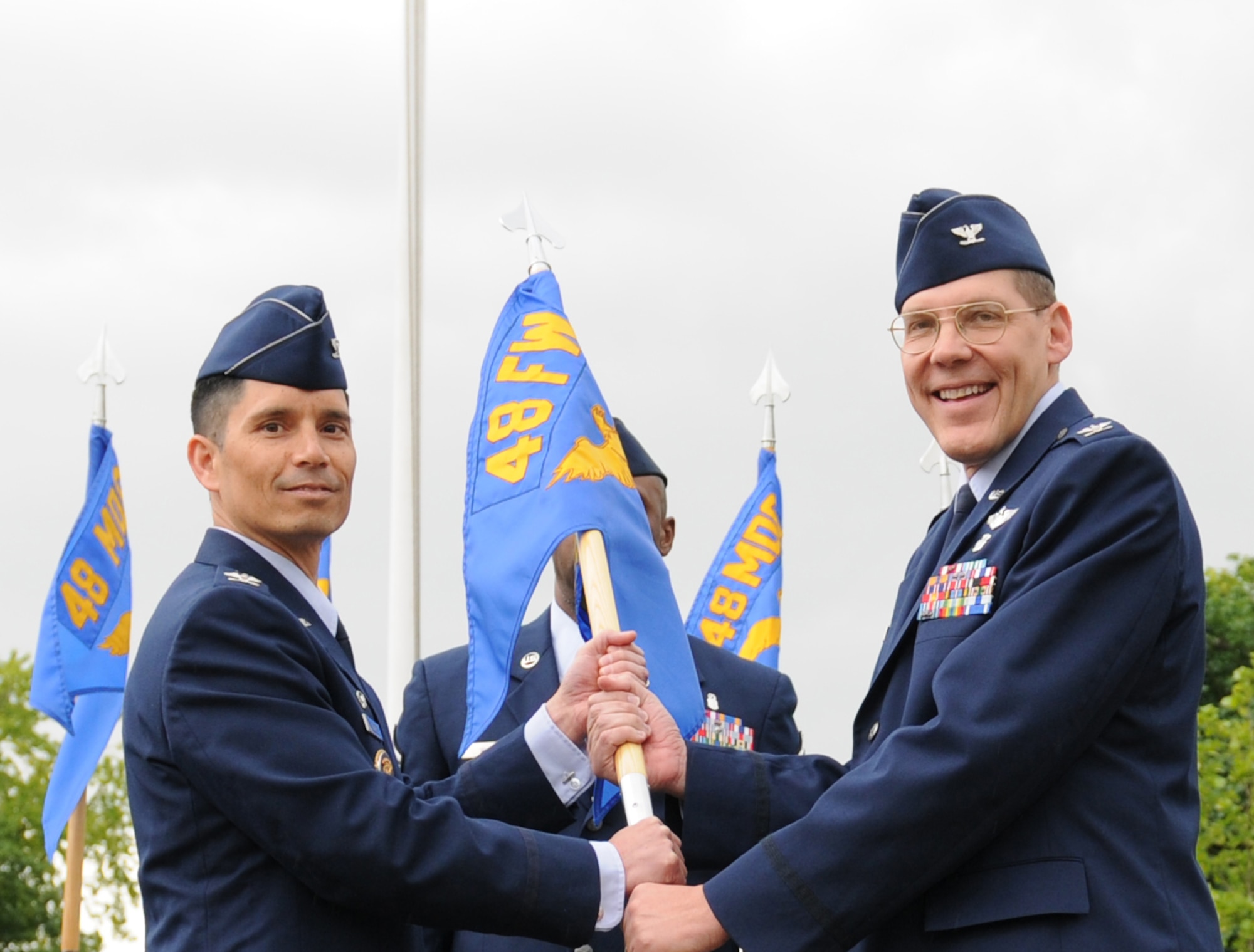 ROYAL AIR FORCE LAKENHEATH, England - Col. John Quintas, 48th Fighter Wing commander, presents the 48th Medical Group guidon Col. Joseph Legan, 48th MDG commander on May 11, 2011. Col. Joseph Legan assumed command of the 48th MDG, which is home to the Best Hospital in the Air Force for two consecutive years, from interim commander Col. David Hocking. (U.S. Air Force photo/Airman Cory Payne)