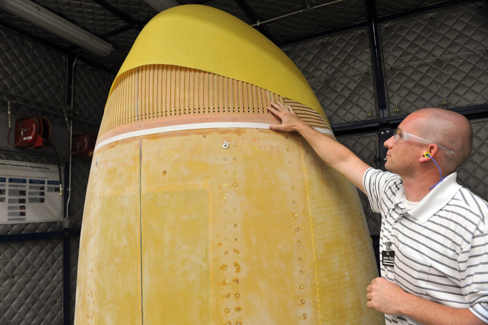 Jeremy Wood, 573rd Commodities Maintenance Sheet Metal Manufacturing Flight chief, shows off a stripped C-130 Combat Talon II radome which went through the new process. U. S. Air Force photo by Tommie Horton