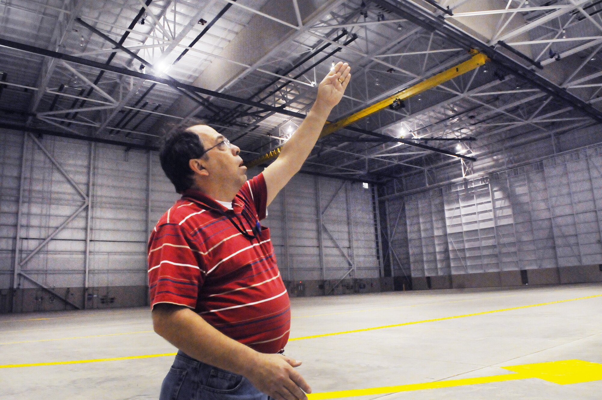 David Trescott talks about the crane system in the new C-130 hangar. U. S. Air Force photo by Sue Sapp