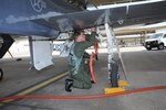 Lt. David Brandon, 435th Fighter Training Squadron, performs a final walk-around safety check of his T-38 Talon Aircraft prior to a morning training mission at Randolph Air Force Base, Texas May 9, 2011.(U.S. Air Force photo/Rich McFadden)