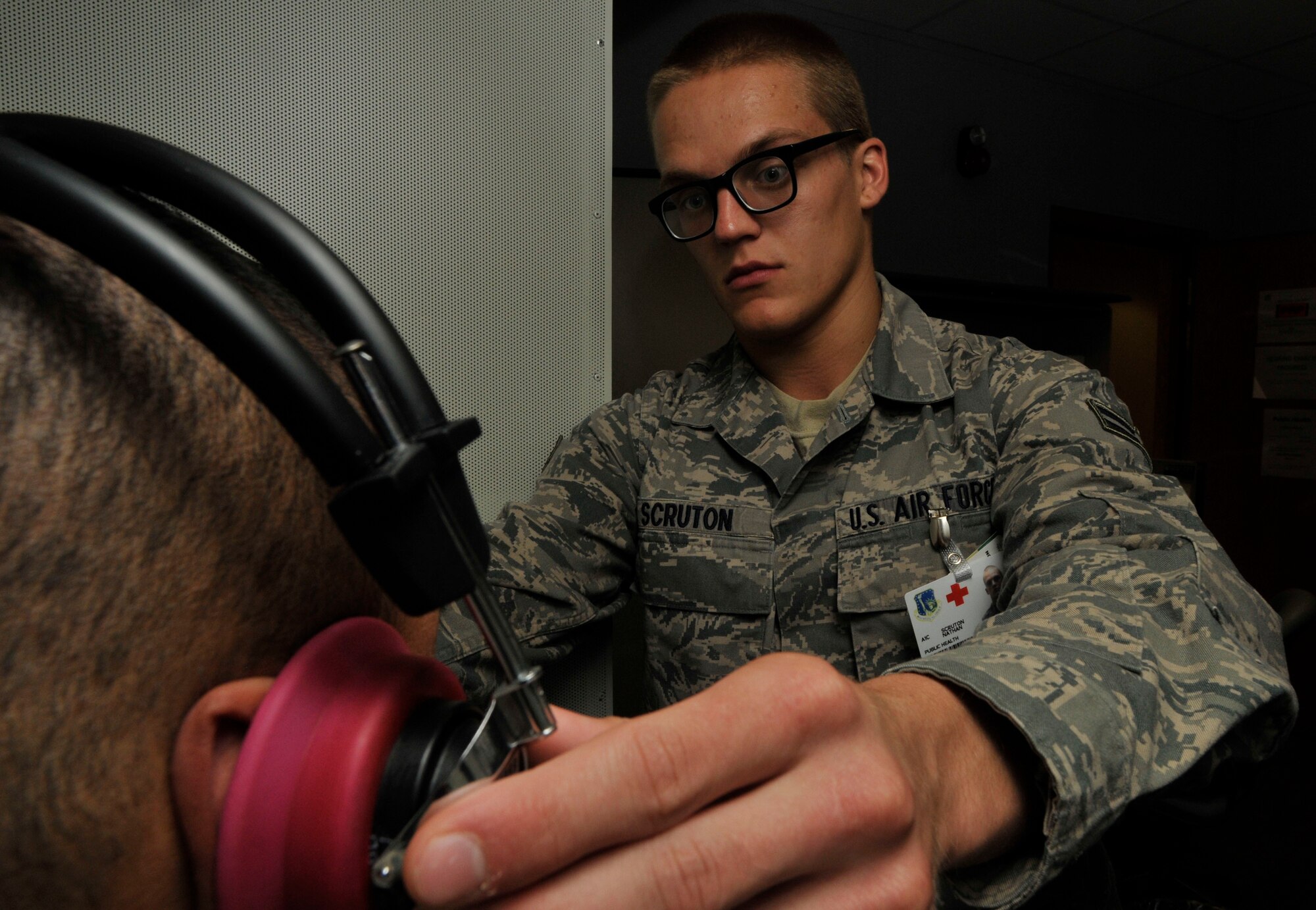 ROYAL AIR FORCE LAKENHEATH, England--Airman 1st Class Nathan Scruton administrates a hearing test at the flight medicine center on May 10, 2011. Airman Scruton was nominated for a Liberty Spotlight because he displays the core value of 'Excellence in All We Do'. (U.S. Air Force photo/Senior Airman Eboni Reams)