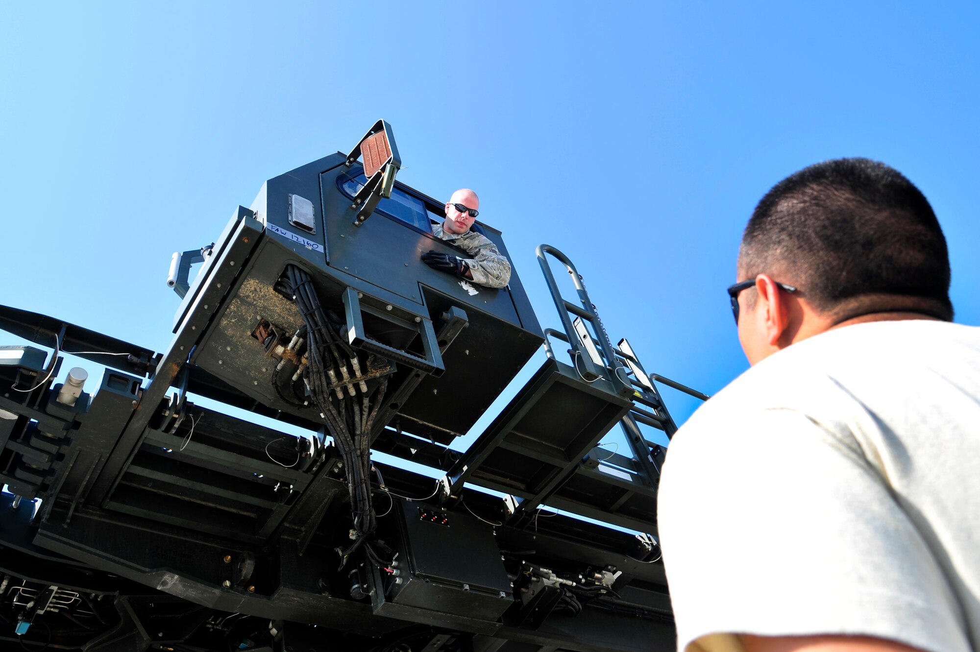 Airman 1st Class Jeremy Swiggum (left) and Senior Airman Jesus Sanchez, air transportation specialists assigned to the 621st Contingency Response Wing, perform an inspection of a next generation small loader at Mihail Kogalniceanu Air Base, Romania, May 10.  Fifty-four members of the 621st CRW deployed here as a contingency response element to extend airfield capability supporting multi-modal operations during a U.S. Transportation Command proof-of-principle evaluation. The process is expected to demonstrate the feasibility of using the air base as a hub for equipment flowing into and out of Afghanistan.  (U.S. Air Force photo by Master Sgt. Laura K. Deckman/released)
