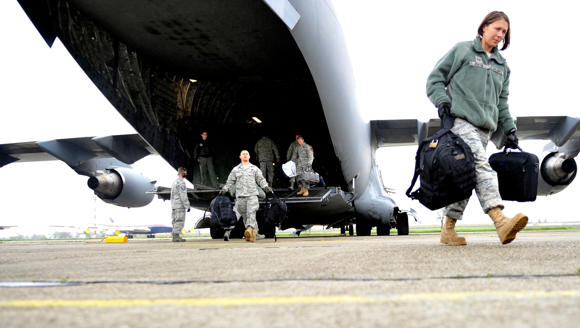 Members of the 621st Contingency Response Element off-load a C-17 Globemaster III upon arrival at Mihail Kogalniceanu Air Base, Romania, May 9.  Fifty-four members of the 621st Contingency Response Wing deployed here to extend airfield capability supporting multi-modal operations during a U.S. Transportation Command proof-of-principle evaluation. The process is expected to demonstrate the feasibility of using the air base as a hub for equipment flowing into and out of Afghanistan.  (U.S. Air Force photo by Master Sgt. Laura K. Deckman/released)
