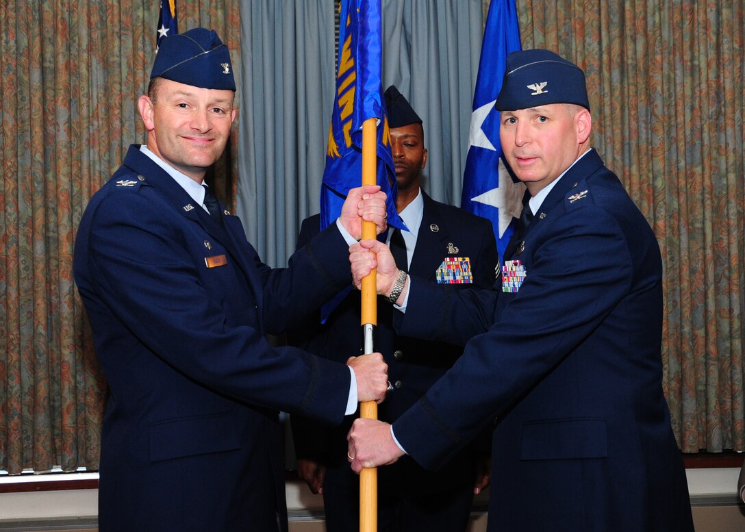 Col. John Long, 11th Mission Support Group commander, passes the 11th MSG guiedon to Col. Ken Rizer, 11th Wing/Joint Base Andrews commander, during a ceremony here May 10, 2011. The ceremony was followed by a Retirement Ceremony honoring Colonel Long. (U.S. Air Force photo/Staff Sgt. Nichelle Anderson/Released)
