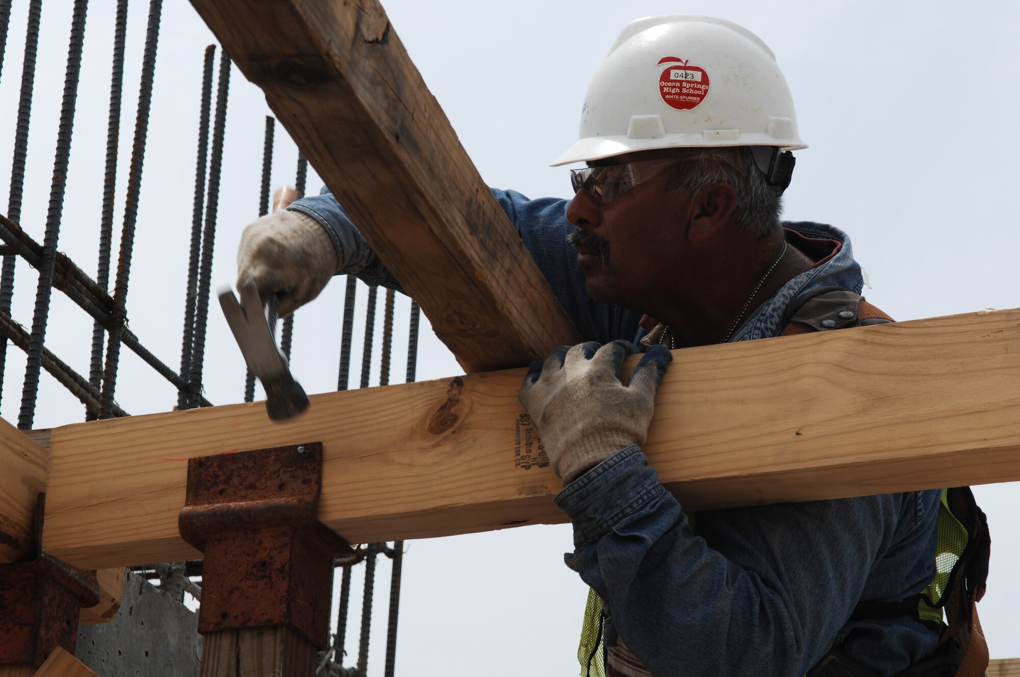 GOODFELLOW AIR FORCE BASE, Texas -- Juan Gutierres, a subcontractor with Associated Professional Engineering Consultants, nails together shoring for the second floor of the new dorms, May 9, 2011. The shoring will support the weight of the concrete as it settles. (U.S. Air Force photo/Staff Sgt. Laura R. McFarlane) 