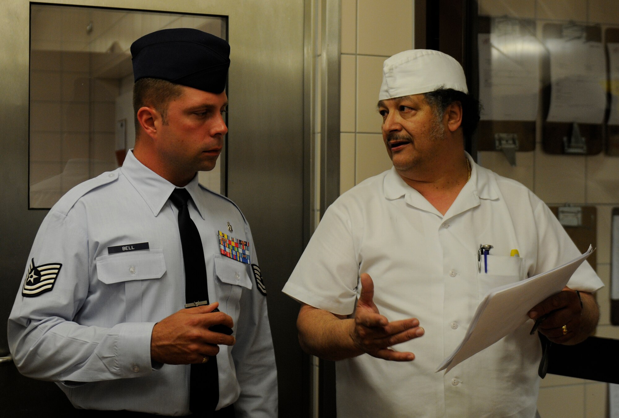 SPANGDAHLEM AIR BASE, Germany – Tech. Sgt. Michael Bell, U.S. Air Force Food Vulnerability Assessment program manager, speaks with Joe Santiago, Club Eifel chef, about food transportation here May 9. FVAs are performed every three years to ensure all food establishments on base use programs and procedures to prevent and eliminate the contamination of food. (U.S. Air Force photo/Airman 1st Class Brittney Frees)