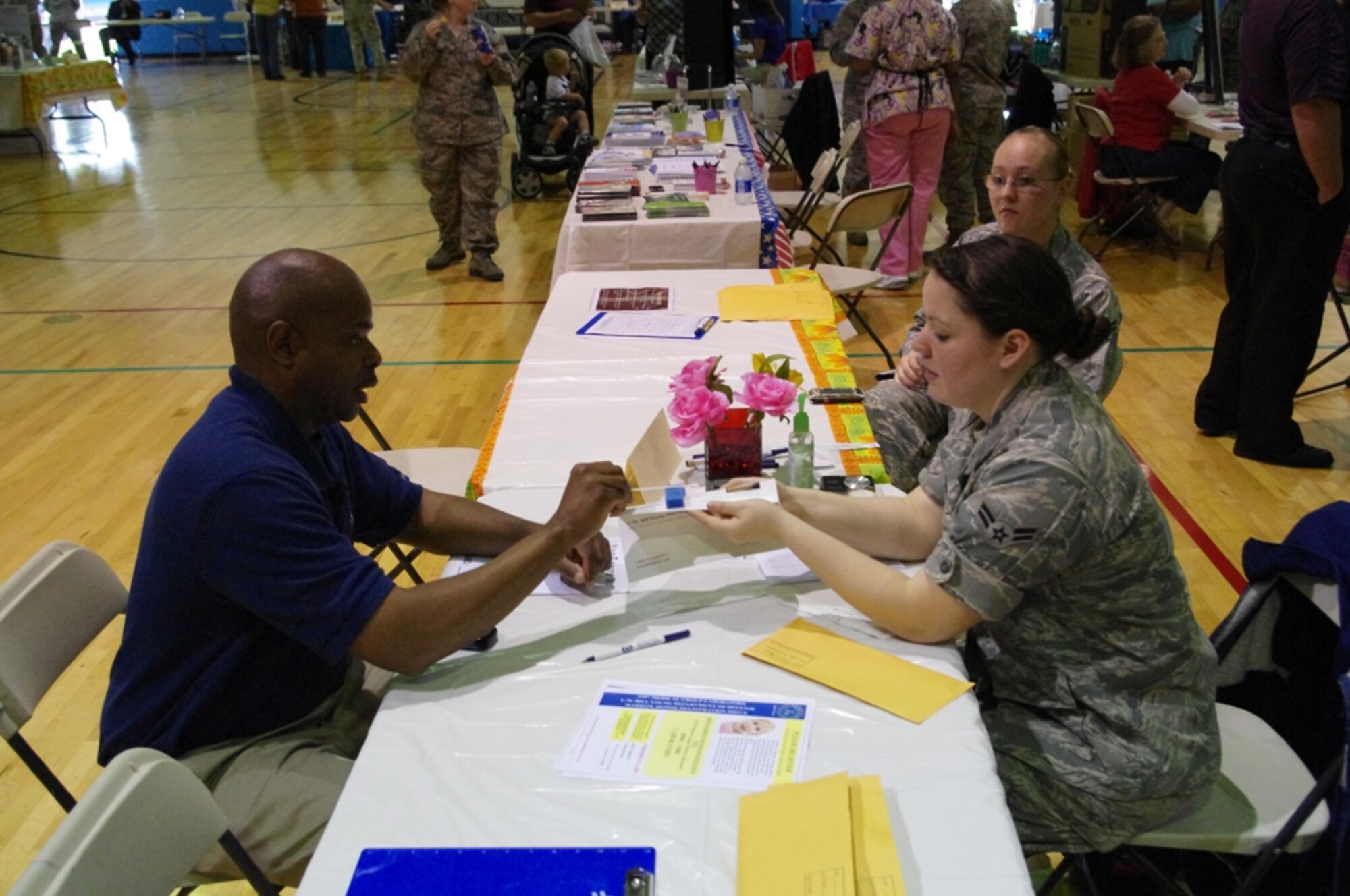 A member of the 375th Medical Group registers a Fitness Center employee as a bone marrow donor. Registering to be a donor is painless and takes a few minutes, but being matched as a donor candidate could save a life. (U.S. Air Force photo/Shawn Saunders) 