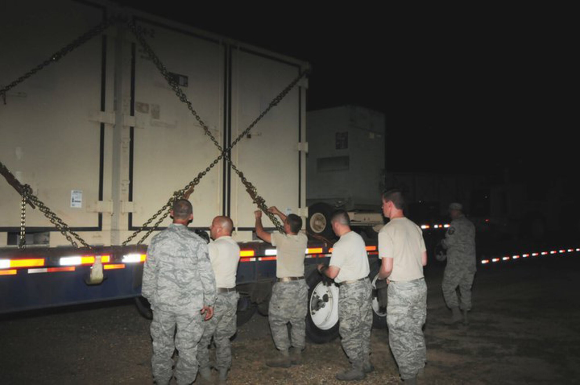 Airmen from the 188th Fighter Wing's Civil Engineering Squadron at Fort Smith release chains holding shipping containers for the Disaster Relief Bed-down System (DRBS) at McGehee, Ark., May 11, 2011. The Airmen were part of an advance team for the Arkansas National Guard deploying to the southeast region of the state. The DRBS is a self-contained support facility for disaster response teams. The facility can house, feed and provide shower and laundry services for up to 150 Guardsmen. (Photo by Staff Sgt. Julian Johnson, Arkansas National Guard Public Affairs.)