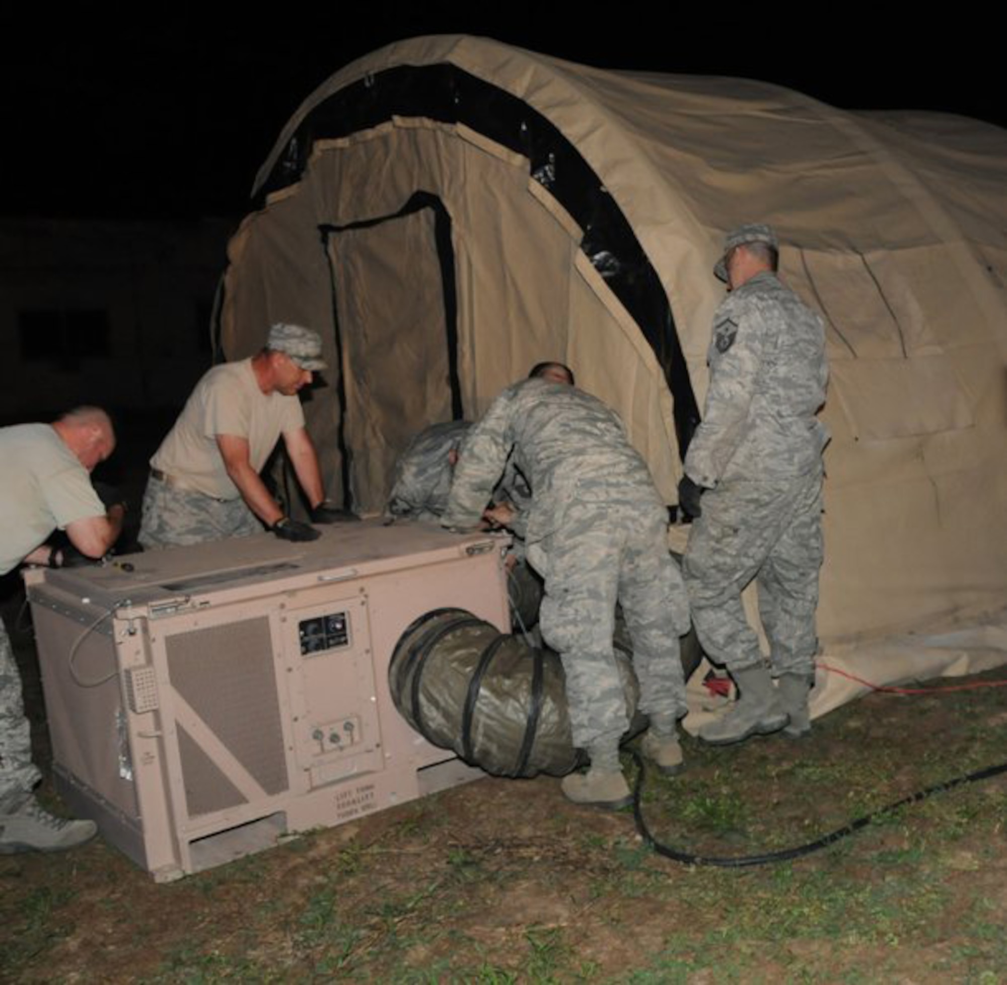 Members of the 188th Fighter Wing Civil Engineering Squadron from Fort Smith, Ark., assemble structures that make up the Disaster Relief Bed-down System (DRBS). Fully established, the DRBS is a self-sustaining tent city roughly the size of a football field and provides housing, food service, shower and laundry support for up to 150 Guardsmen. The complex has its own power generation, water purification systems, as well as heating and air conditioning throughout. (Photo by Staff Sgt. Julian Johnson, Arkansas National Guard Public Affairs.)
