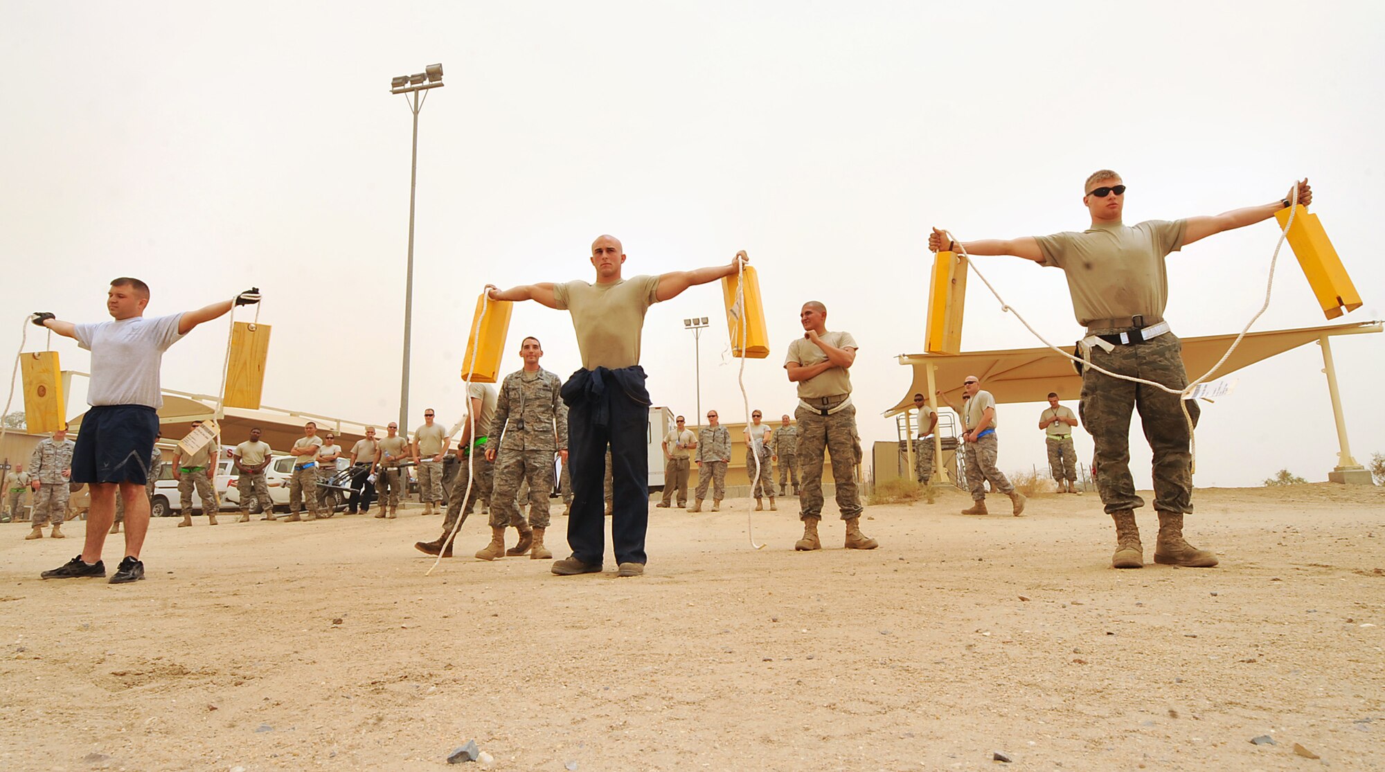 The 386th Expeditionary Aircraft Maintenance Squadron team holds strong while participating in the chalk hold event in the 386th Expeditionary Maintenance Group Olympics. The event was put on for maintainers to further develop group morale and espirit de corps. (U.S. Air Force photo by Senior Airman Cynthia Spalding)