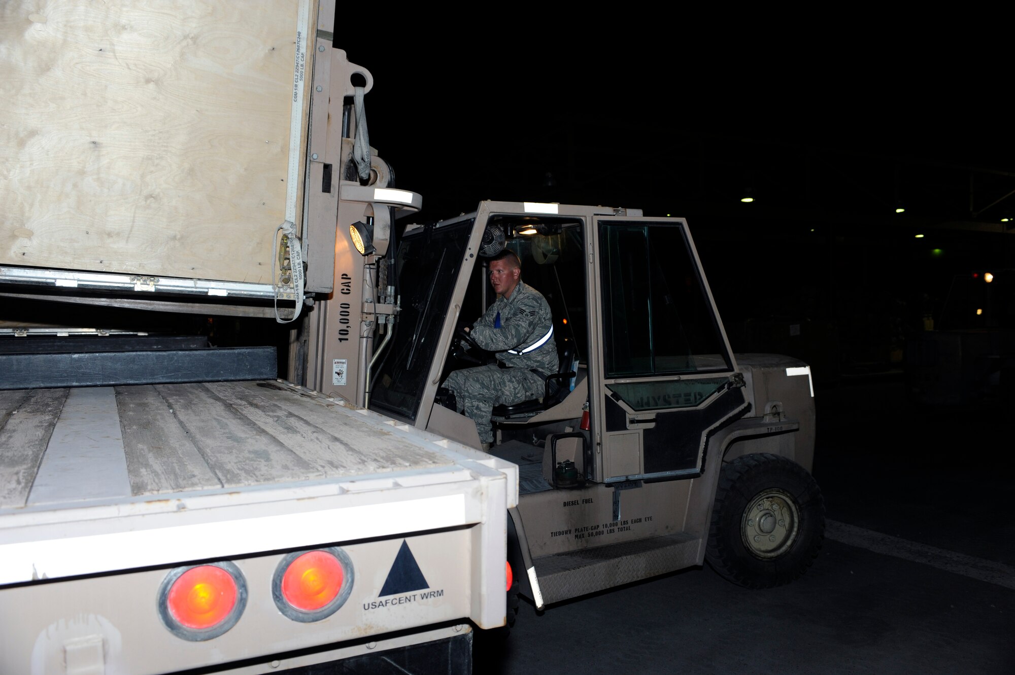 TRANSIT CENTER AT MANAS, Kyrgyzstan -- Senior Airman Rich McGraw, 376th Expeditionary Logistics Readiness Squadron Aerial Port Flight, loads a baggage pallet for an upcoming flight here May 2.  Airman McGraw, 735th Air Mobility Squadron at Hickam Air Base, Hawaii, helped achieve the squadron record of moving 68,000 passengers and 180,000 bags last month and shattered their March record of 57,082 passengers. (U.S. Air Force photo by Tech. Sgt. Jerome C. Baysmore)