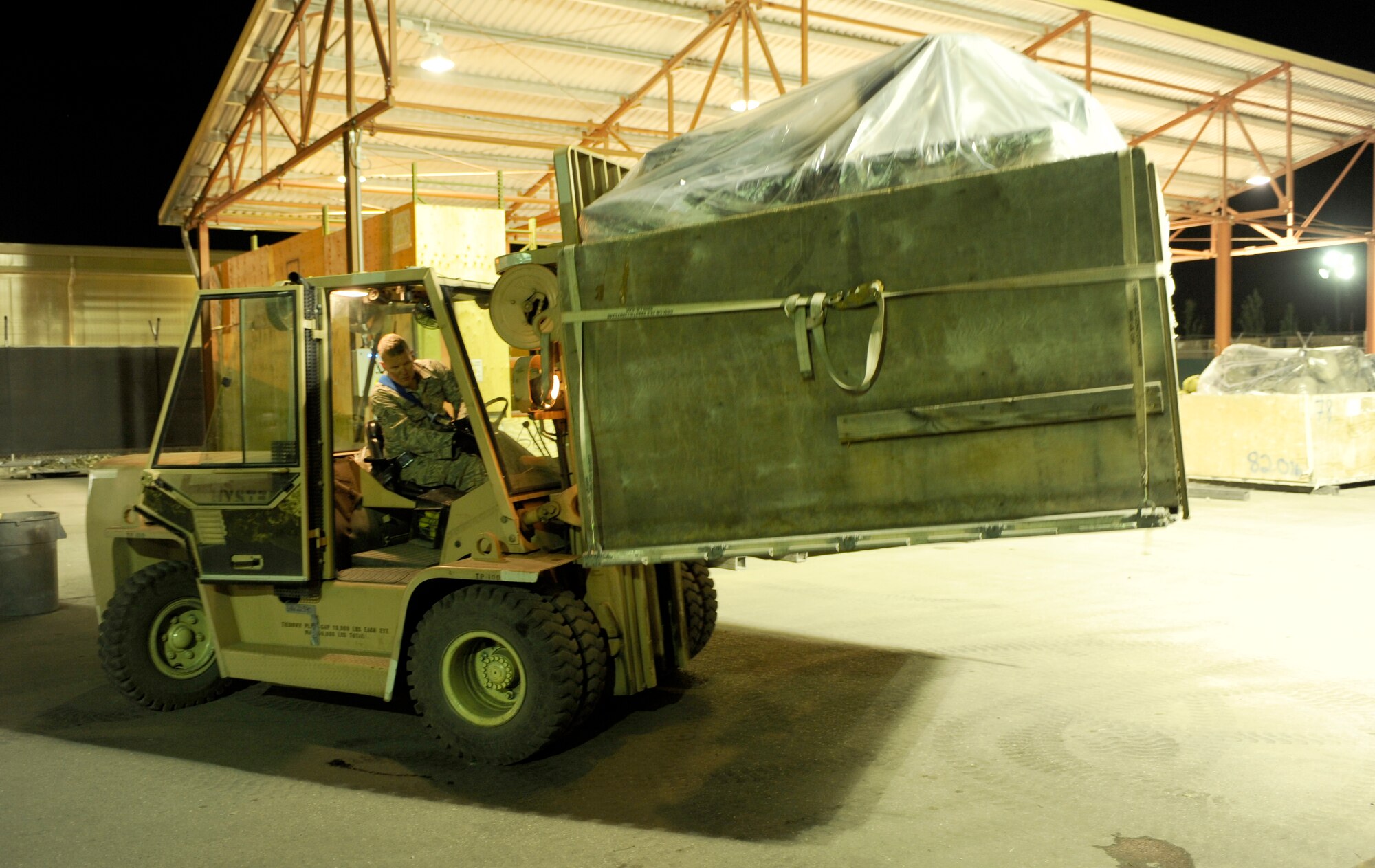 TRANSIT CENTER AT MANAS, Kyrgyzstan -- Senior Airman Rich McGraw, 376th Expeditionary Logistics Readiness Squadron Aerial Port Flight, processes a baggage pallet for an upcoming flight here May 2.  Airman McGraw, 735th Air Mobility Squadron at Hickam Air Base, Hawaii, helped achieve the squadron record of moving 68,000 passengers and 180,000 bags last month and shattered their March record of 57,082 passengers. (U.S. Air Force photo by Tech. Sgt. Jerome C. Baysmore)