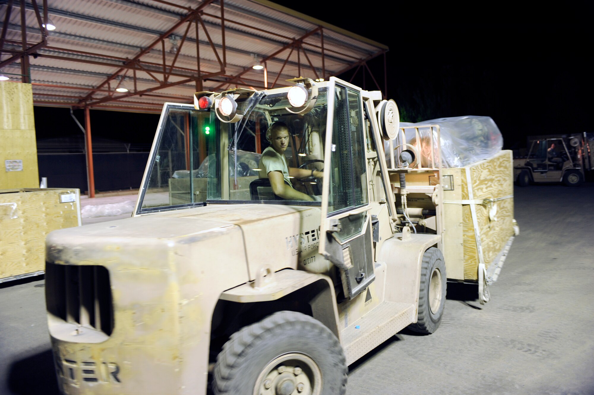 TRANSIT CENTER AT MANAS, Kyrgyzstan -- Airman 1st Class Koy Sauer, 376th Expeditionary Logistics Readiness Squadron Aerial Port Flight, sorts baggage pallets here May 2.  Airman Sauer, deployed from the 437th Aerial Port Squadron at Joint Base Charleston, S.C., helped achieve the squadron record of moving 68,000 passengers and 180,000 bags last month to shattered their March record of 57,082 passengers. (U.S. Air Force photo by Tech. Sgt. Jerome C. Baysmore)