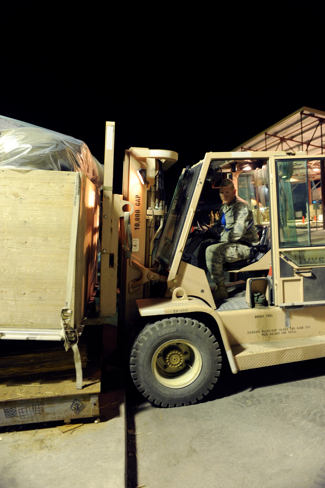 TRANSIT CENTER AT MANAS, Kyrgyzstan -- Senior Airman Rich McGraw, 376th Expeditionary Logistics Readiness Squadron Aerial Port Flight, weighs and processes a baggage pallet for an upcoming flight here May 2.  Airman McGraw, 735th Air Mobility Squadron at Hickam Air Base, Hawaii, helped achieve the squadron record of moving 68,000 passengers and 180,000 bags last month and shattered their March record of 57,082 passengers. (U.S. Air Force photo by Tech. Sgt. Jerome C. Baysmore)