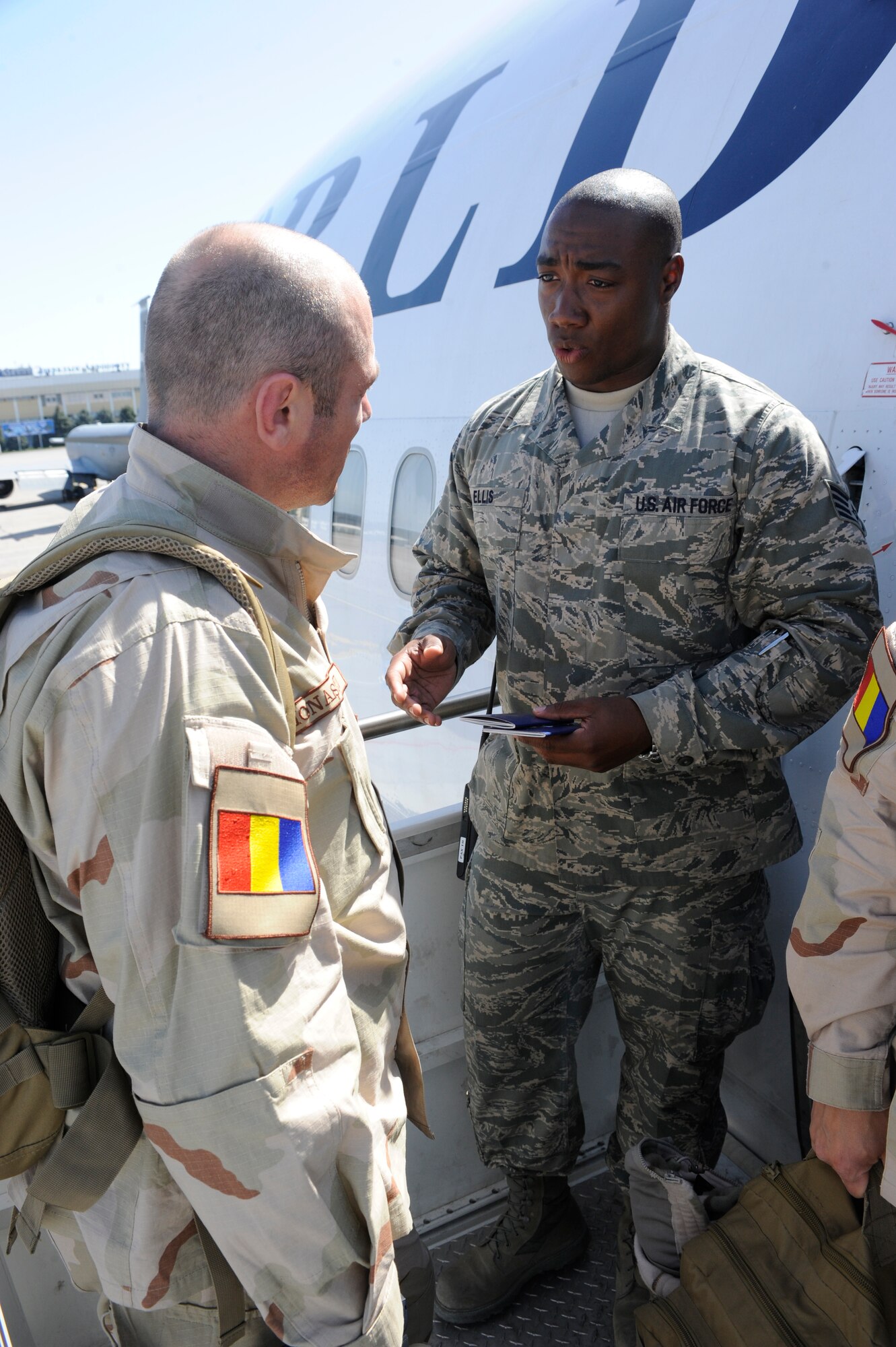 TRANSIT CENTER AT MANAS, Kyrgyzstan -- Staff Sgt. Marvin Ellis, 376th Expeditionary Logistics Readiness Squadron Passenger Terminal representative, answers questions and goes over procedures with newly arrived coalition forces personnel here May 2.  Sergeant Ellis, deployed from the 734th Air Mobility Squadron at Anderson Air Base, Guam, helped achieve the squadron record of moving 68,000 passengers and 180,000 bags last month and shattered their March record of 57,082 passengers. (U.S. Air Force photo by Tech. Sgt. Jerome C. Baysmore)