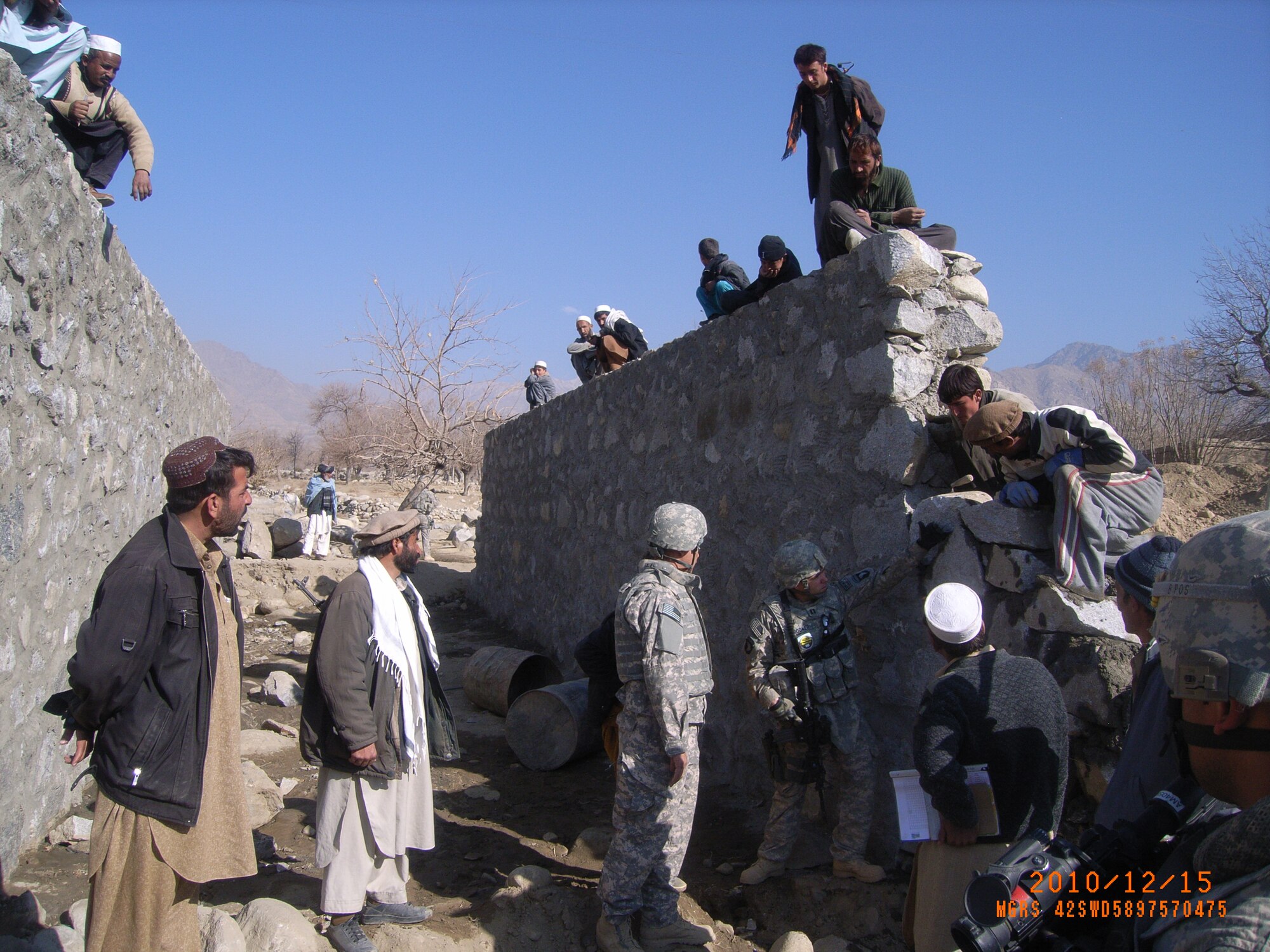 U.S. Air Force Capt. Brandon Rocker provides feedback regarding the construction of a perimeter wall to local construction workers in Kapisa, Afghanistan. ( U.S. Air Force photo/Master Sgt. Jonathan Estrada)