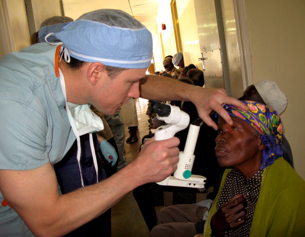 U.S. Army Maj. (Dr.) Travis Frazier screens a potential candidate for cataract surgery during a clinic in Lilongwe, Malawi, May 11, 2011. Frazier is an opthamologist at Madigan Army Medical Center at Fort Lewis, Wash. “I get goose bumps just talking about it,” he said of the impact.
