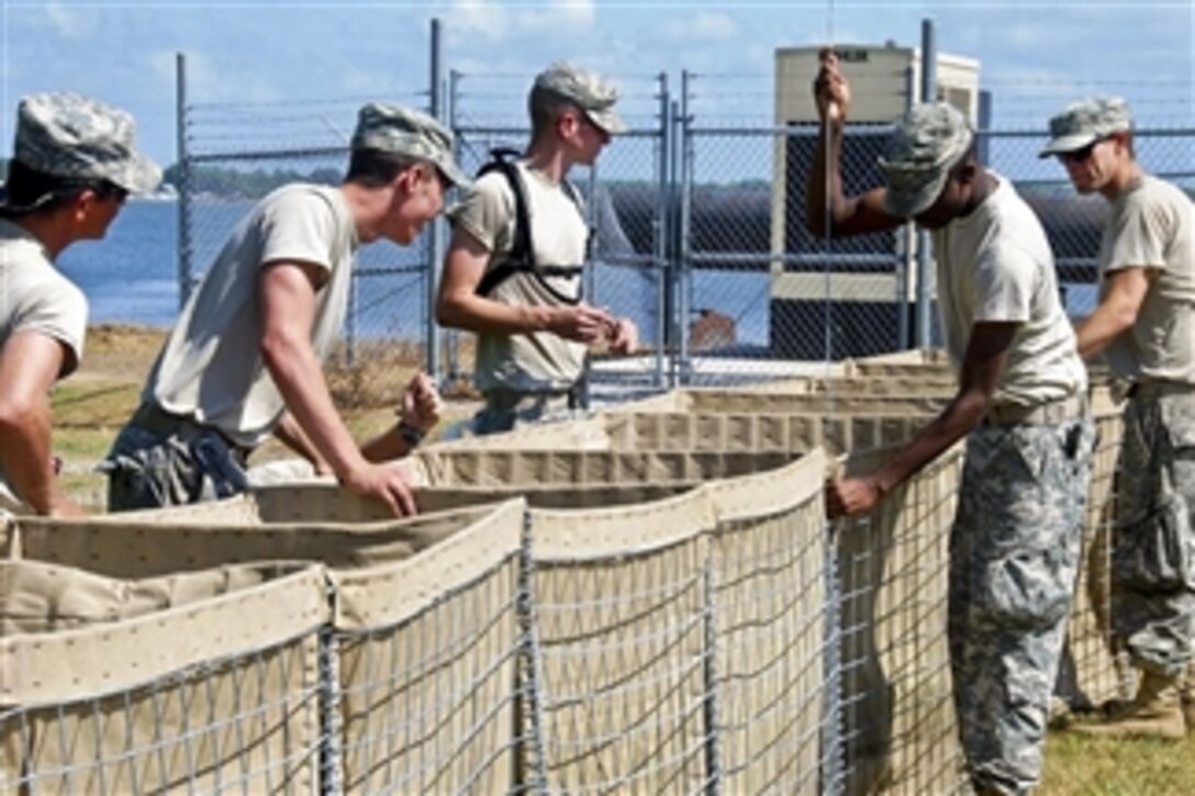 U.S. Army soldiers construct sand-filled basket barriers on top of a levee along Lake Palourde in Morgan City, La., on May 10, 2011.  The soldiers, members of the Louisiana National Guard assigned to the 927th and 928th Engineer companies, are adding three feet of protection to the levee to block possible flooding from the rising Mississippi River.  