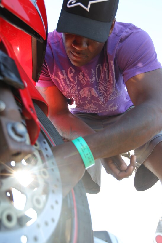 Staff Sgt. Shawn Williams, an instructor with the Marine Corps Communication-Electronics School, inspects his bike during a Jason Pridmore’s Star School class May 13, 2011.