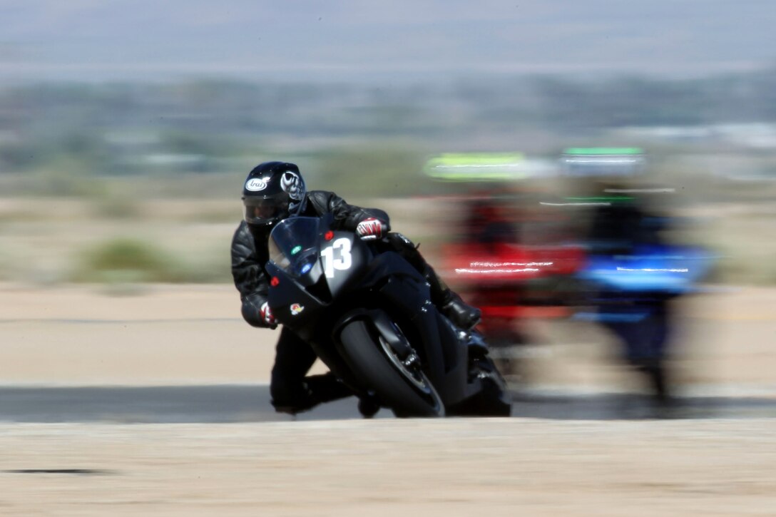 Frank Santiago, a rider coach for base safety, flies around a corner of Chuckwalla Valley Raceway, practicing what he has learned from classes during a Jason Pridmore’s Star School class sponsored by the Combat Center’s Base Safety May 13, 2011.