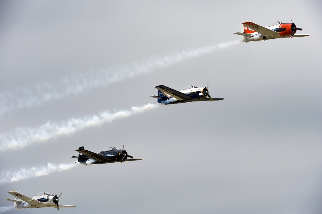 The Trojan Horsemen T-28 Warbirds Aerobatic Formation Demonstration Team stair step through the sky during the AirPower over Hampton Roads open house at Langley Air Force Base, Va., May 14, 2011. The open house is a free three-day event featuring aerial demonstrations by modern and historical military aircraft and civilian performers. (U.S. Air Force photo/Senior Airman Zachary Wolf)(RELEASED)