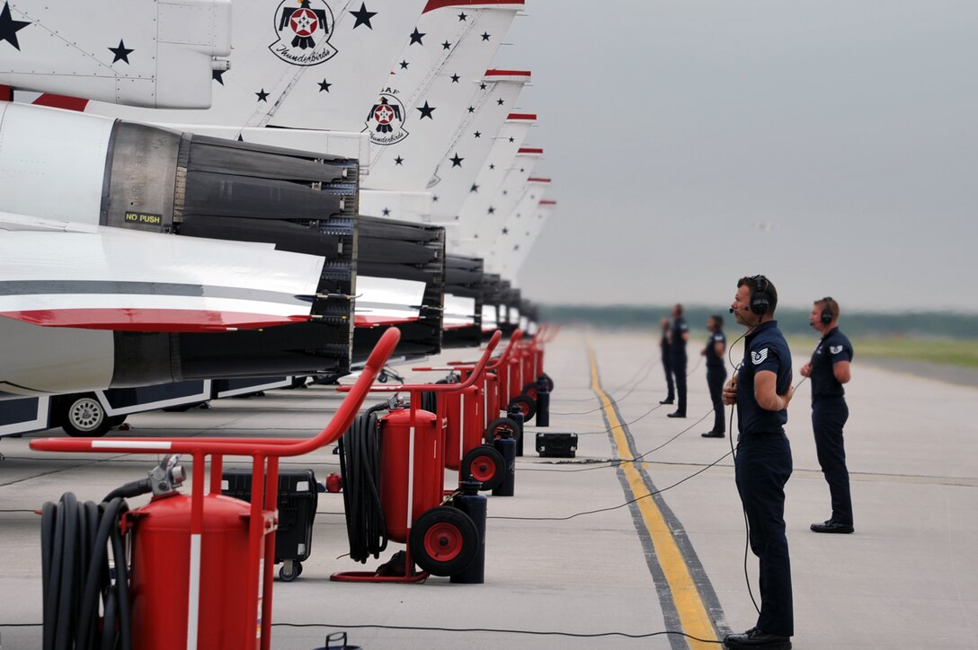 The U.S. Air Force Air Demonstration Squadron, Thunderbirds, team members perform a synchronized pre-flight inspection prior to take-off during the AirPower over Hampton Roads open house at Langley Air Force Base, Va., May 13, 2011. The Thunderbirds headlined the open house and performed precision aerial maneuvers, demonstrating the capabilities of high-performance aircraft to the Hampton Roads area. (U.S. Air Force photo by Airman 1st Class Camilla Griffin/RELEASED)

