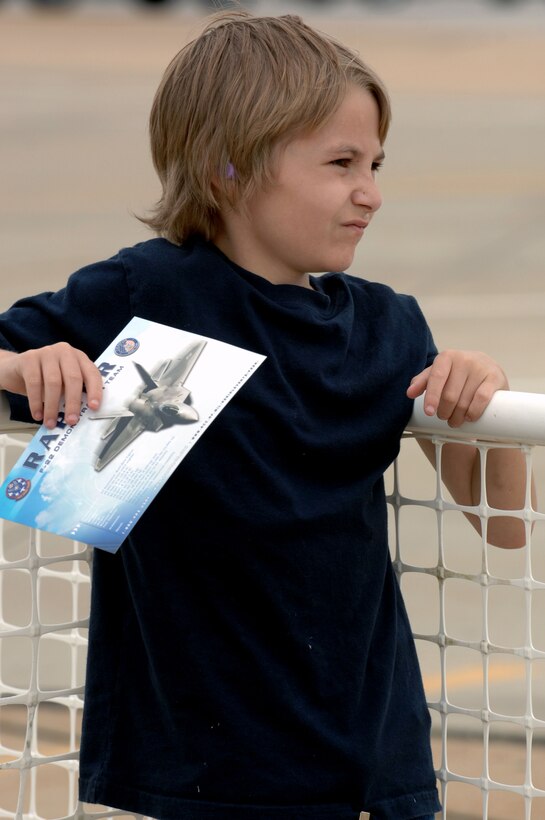 Brandon Bailey, a resident of Newport News, Va., watches as the U.S. Air Force Air Demonstration Squadron, the Thunderbirds, demonstrates aerial stunts during a performance at the AirPower over Hampton Roads open house at Langley Air Force Base, Va., May 13, 2011. The Thunderbirds headlined the open house, performing precision aerial maneuvers and demonstrating the capabilities of high-performance aircraft to the Hampton Roads area. (U.S. Air Force photo by Staff Sgt. Jeff Nevison)(RELEASED)
