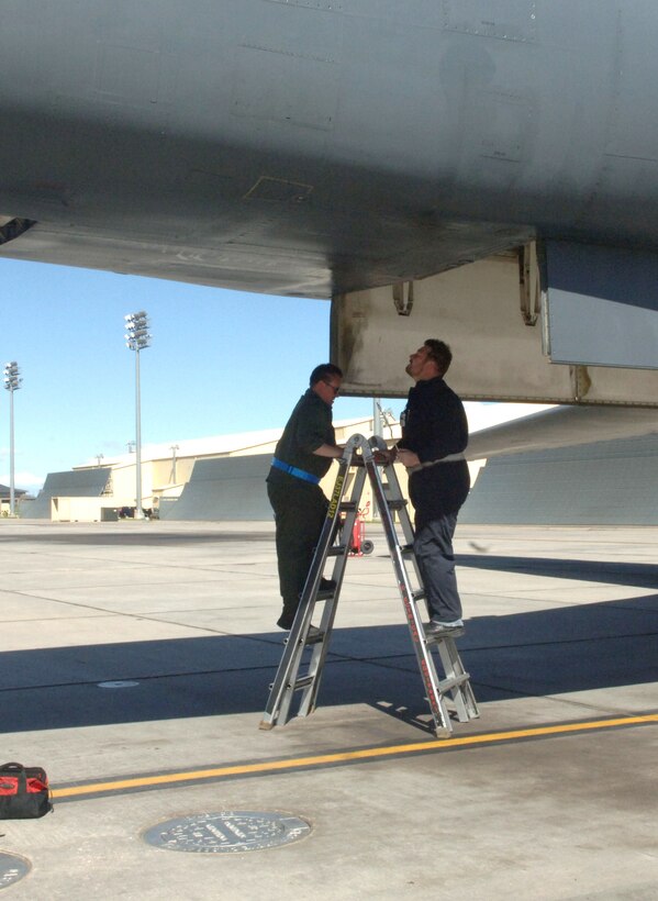 Retired Tech. Sergeants, Ron Tidwell and Scott Harrington, now M-1 Support Services contractors, inspect a B-1B Lancer before takeoff at Ellsworth Air Force Base, S.D., May 10, 2011.  Mr. Tidwell and Mr. Harrington together help to train new Airmen and contribute to mission readiness with their years of B-1 experience.  (U.S. Air Force photo by Airman Alessandra N. Gamboa)