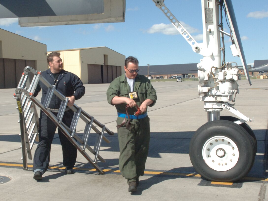Retired Tech. Sergeants, Ron Tidwell and Scott Harrington, now M-1 Support Services contractors, prepare to inspect a B-1B Lancer before takeoff at Ellsworth Air Force Base, S.D., May 10, 2011.  Mr. Tidwell and Mr. Harrington share a combined total of more than 40 years worth of B-1B mechanical experience, reducing the amount of time it takes to prepare jets in half. (U.S. Air Force photo by Airman Alessandra N. Gamboa)