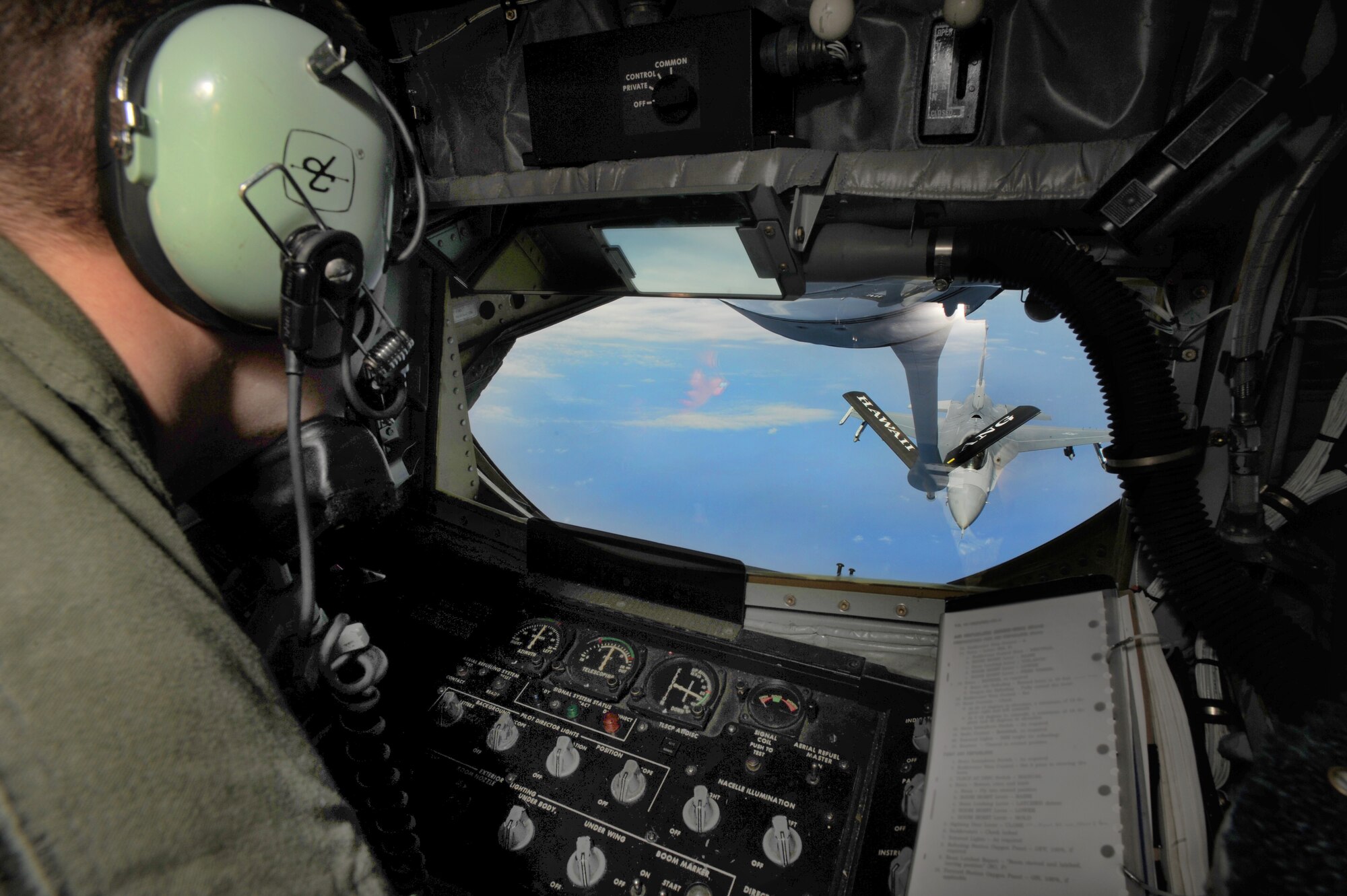 Senior Airman Gregory Bush operates the boom to refuel an F-22 over the Pacific during a routine aerial refueling mission May 12. The flight carried thousands of pounds of fuel as well as more than 30 Junior ROTC students from various high schools around the state. (U.S. Air Force Photo/Senior Airman Lauren Main)