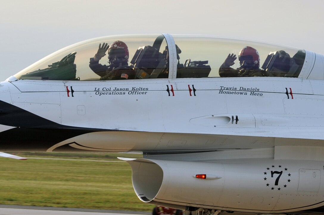 Lt. Col. Jason Koltes, Air Force Thunderbirds Premier Demonstration Team operations officer, and Travis Daniels, emergency medical technician, arrive at Langley Air Force Base, Va., May 12, 2011. The Thunderbirds selected Travis Daniels as the AirPower over Hampton Roads Hometown Hero, for which they rewarded him with an orientation flight in an F-16 Fighting Falcon. (U.S. Air Force photo by Airman 1st Class Camilla Griffin)(RELEASED)