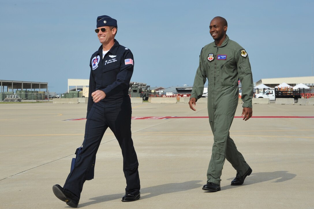 Lt. Col. Jason Koltes, Air Force Thunderbirds Premier Demonstration Team operations officer, and Mr. Travis Daniels, emergency medical technician, “step” to the F-16 Fighting Falcons at Langley Air Force Base, Va., May 12, 2011. The Thunderbirds selected Mr. Daniels as the AirPower over Hampton Roads Hometown Hero, for which they rewarded him with an orientation flight in an F-16 Fighting Falcon. (U.S. Air Force photo by Airman 1st Class Camilla Griffin)(RELEASED)