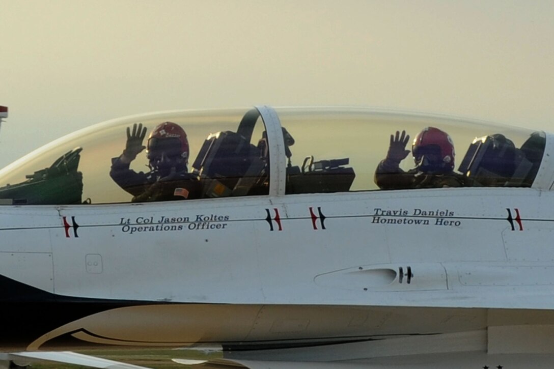 Lt. Col. Jason Koltes, Air Force Thunderbirds Premier Demonstration Team operations officer, and Travis Daniels, emergency medical technician, arrive at Langley Air Force Base, Va., May 12, 2011. The Thunderbirds selected Travis Daniels as the AirPower over Hampton Roads Hometown Hero, for which they rewarded him with an orientation flight in an F-16 Fighting Falcon. (U.S. Air Force photo by Airman 1st Class Racheal Watson)(RELEASED)