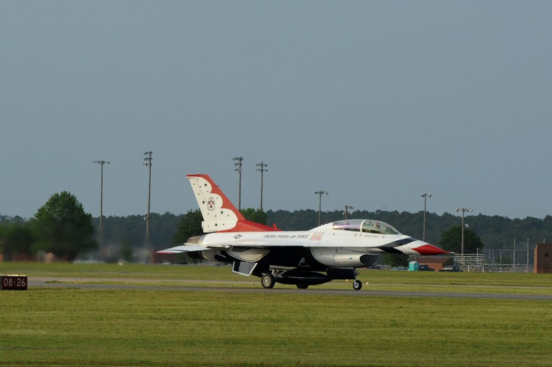 Lt. Col. Jason Koltes, Air Force Thunderbirds Premier Demonstration Team operations officer, and Travis Daniels, emergency medical technician, arrive at Langley Air Force Base, Va., May 12, 2011. The Thunderbirds selected Travis Daniels as the AirPower over Hampton Roads Hometown Hero, for which they rewarded him with an orientation flight in an F-16 Fighting Falcon. (U.S. Air Force photo by Airman 1st Class Racheal Watson)(RELEASED)