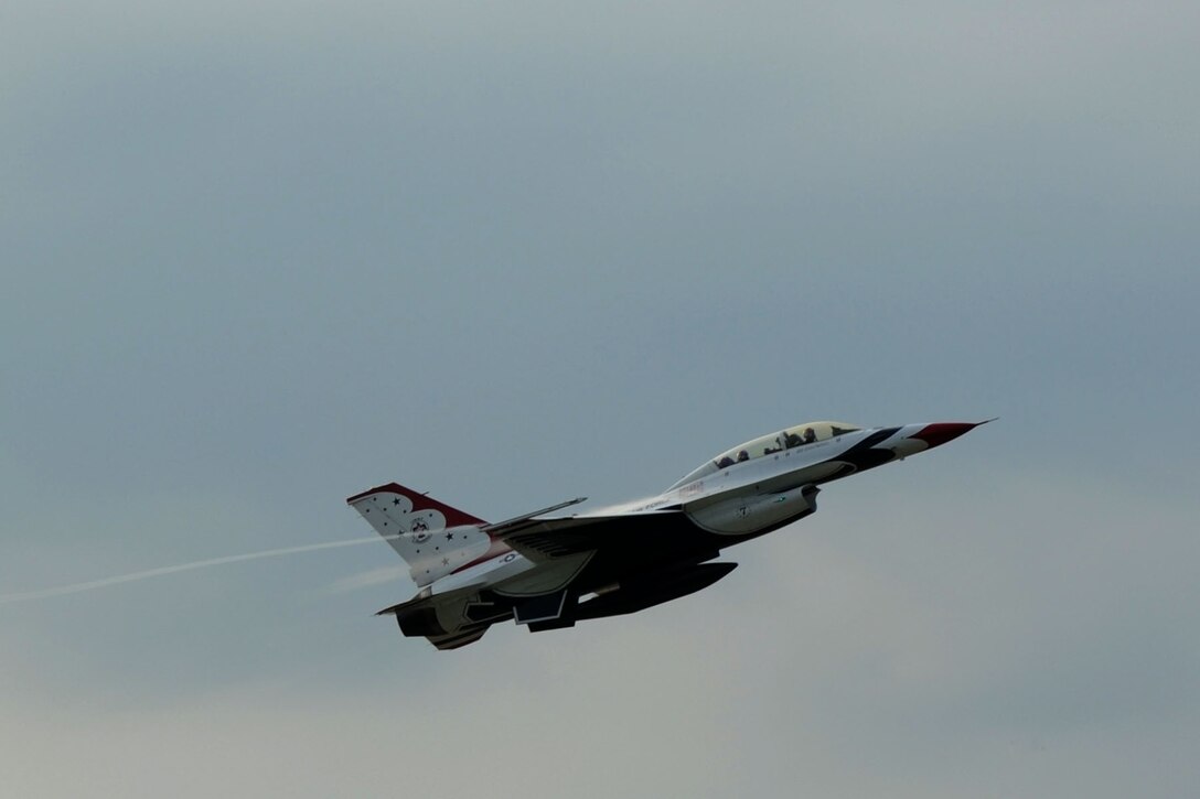 Lt. Col. Jason Koltes, Air Force Thunderbirds Premier Demonstration Team operations officer, and Travis Daniels, emergency medical technician, depart from Langley Air Force Base, Va., May 12, 2011. The Thunderbirds selected Travis Daniels as the AirPower over Hampton Roads Hometown Hero, for which they rewarded him with an orientation flight in an F-16 Fighting Falcon. (U.S. Air Force photo by Airman 1st Class Racheal Watson)(RELEASED)