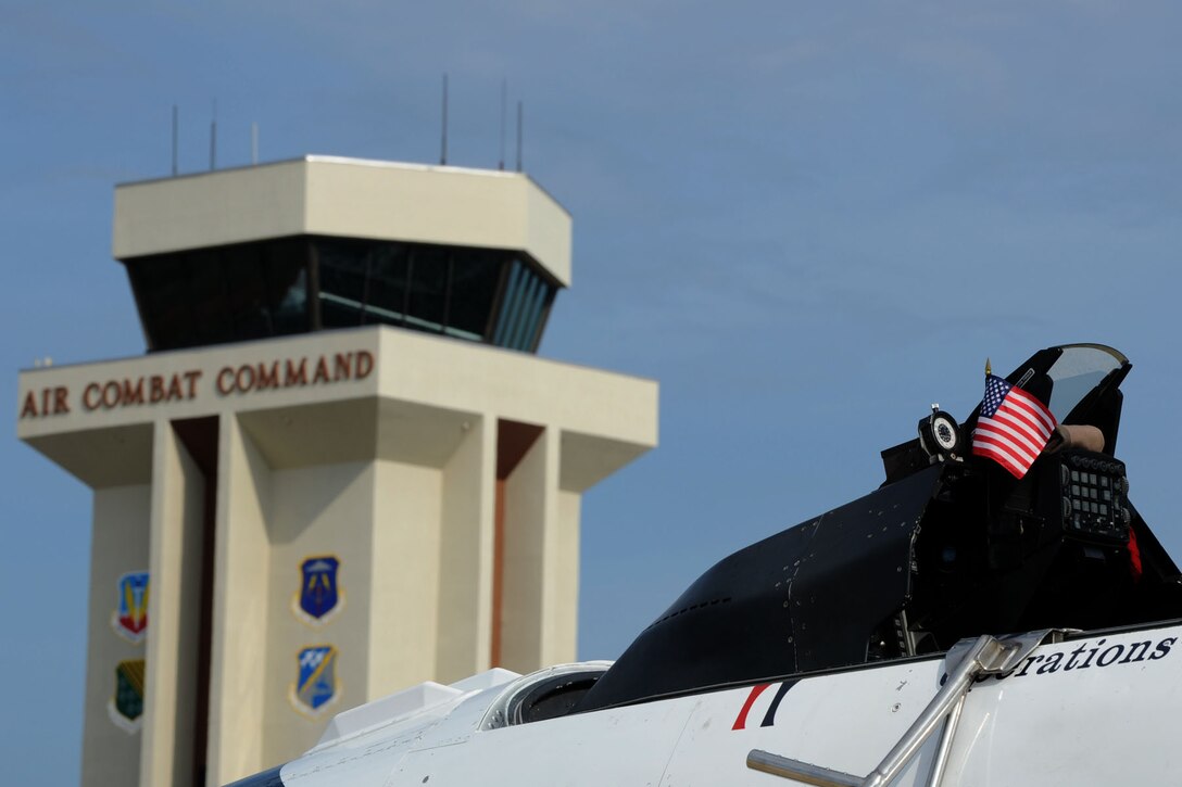 The American Flag is displayed in the cockpit of an F-16 Fighting Falcon at Langley Air Force Base, Va., May 12, 2011. The U.S. Air Force Demonstration Squadron, the Thunderbirds, selected Travis Daniels as the AirPower over Hampton Roads Hometown Hero, for which they rewarded him with an orientation flight in an F-16 Fighting Falcon. (U.S. Air Force photo by Airman 1st Class Racheal Watson/RELEASED)