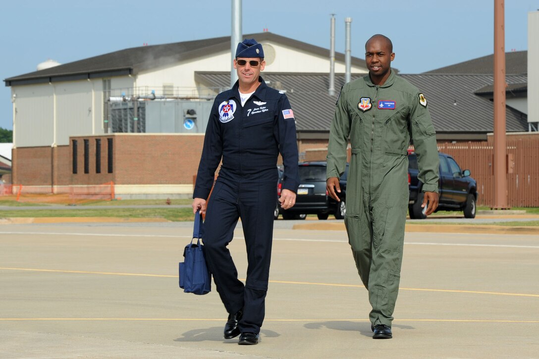 Lt. Col. Jason Koltes, Air Force Thunderbirds Premier Demonstration Team operations officer, and Mr. Travis Daniels, emergency medical technician, “step” to the F-16 Fighting Falcons at Langley Air Force Base, Va., May 12, 2011. The Thunderbirds selected Mr. Daniels as the AirPower over Hampton Roads Hometown Hero, for which they rewarded him with an orientation flight in an F-16 Fighting Falcon. (U.S. Air Force photo by Airman 1st Class Racheal Watson)(RELEASED)