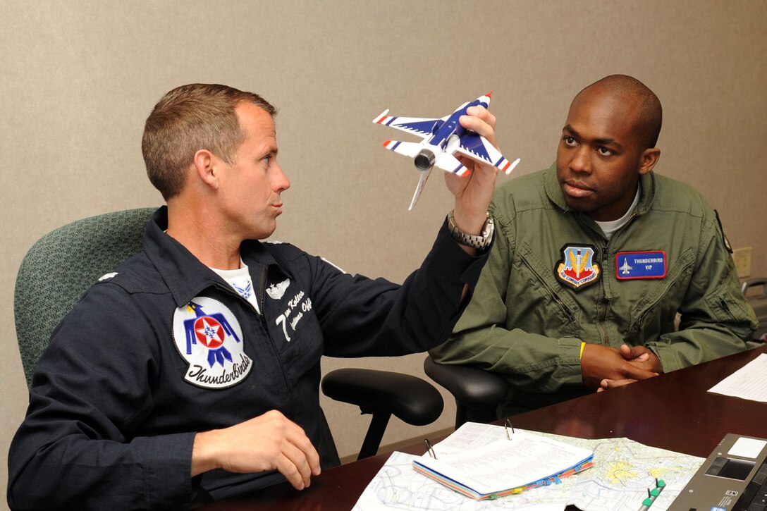 Lt. Col. Jason Koltes, Air Force Thunderbirds Premier Demonstration Team operations officer, briefs Travis Daniels, emergency medical technician, about aerial maneuvers at Langley Air Force Base, Va., May 12, 2011. The Thunderbirds selected Mr. Daniels as the AirPower over Hampton Roads Hometown Hero, for which they rewarded him with an orientation flight in an F-16 Fighting Falcon. (U.S. Air Force photo by Airman 1st Class Racheal Watson)(RELEASED)