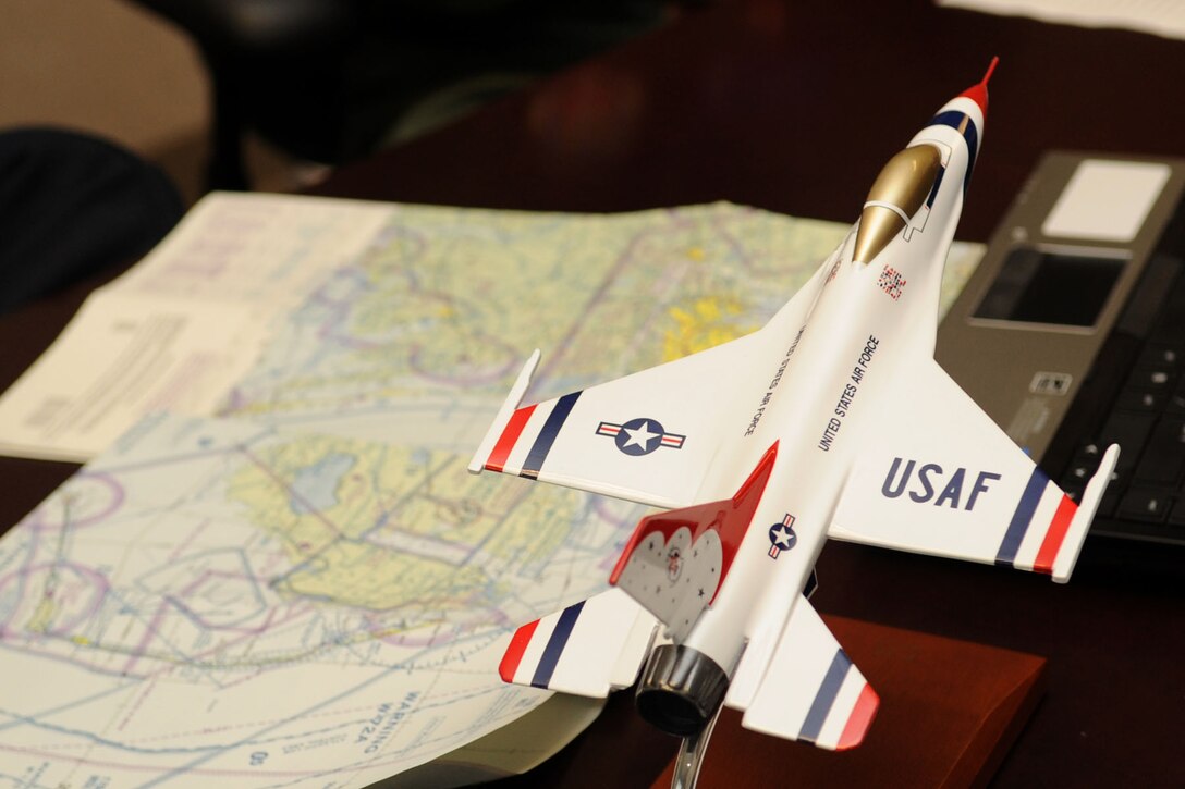 An Air Force Thunderbirds model F-16 Fighting Falcon and local maps are used as props to prepare the hometown hero at Langley Air Force Base, Va., May 12, 2011. The Thunderbirds selected Travis Daniels as the AirPower over Hampton Roads Hometown Hero, for which they rewarded him with an orientation flight in an F-16 Fighting Falcon. (U.S. Air Force photo by Airman 1st Class Racheal Watson)(RELEASED)