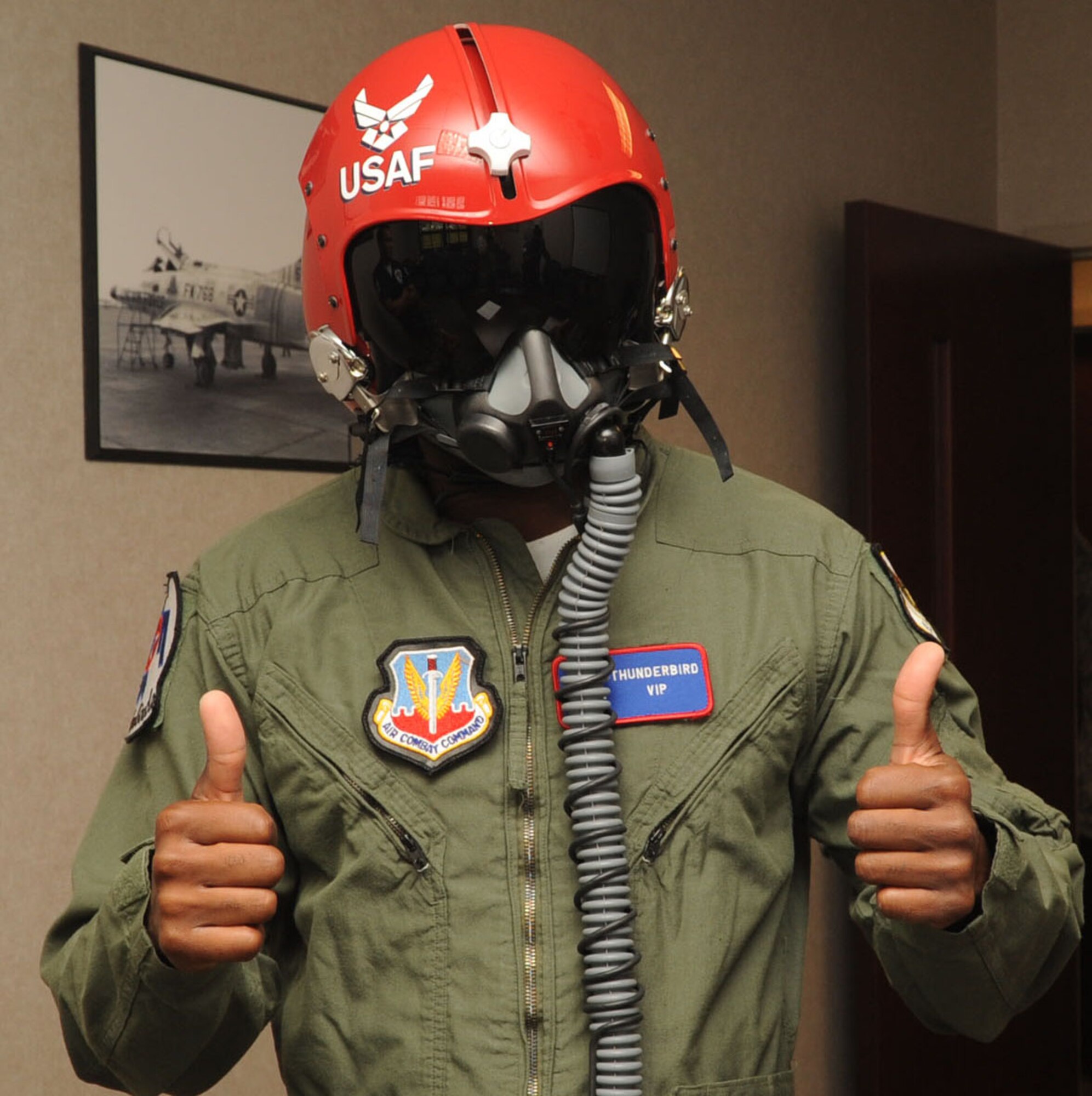Mr. Travis Daniels, emergency medical technician, gives the thumbs up while being issued his flight gear at Langley Air Force Base, Va., May 12, 2011. The Thunderbirds selected Mr. Daniels as the AirPower over Hampton Roads Hometown Hero, for which they rewarded him with an orientation flight in an F-16 Fighting Falcon. (U.S. Air Force photo by Airman 1st Class Racheal Watson)(RELEASED)