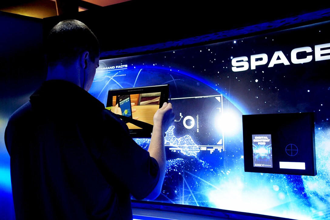 Staff Sgt. Robert Cooper, Air Force recruiter out of Norfolk Va., demonstrates the use of a targeting device during the AirPower over Hampton Roads open house at Langley Air Force Base, Va., May 13, 2011. The open house helps to educate the public on past and present Air Force aerial capabilities, increase recruiting and show appreciation to the local community. (U.S. Air Force photo by Staff Sgt. Ashley Hawkins)(RELEASED)