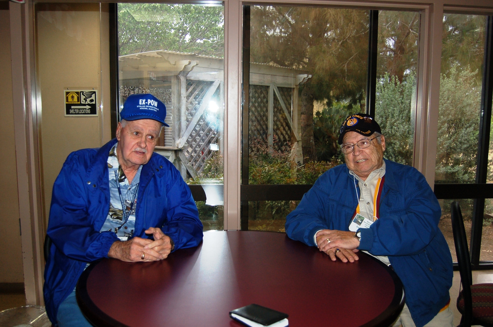 Prisoners of War, Edward Dostie, former B-17 Flying Fortress flight engineer and (at left) Joe Ortiz, a former B-17 Liberator ball turret gunner, recall the days they were held as prisoners in one of the most infamous POW camps during World War II, Stalag Luft 17B, located in Krems, Austria. The World War II veterans took part in a tour of the 433rd Airlift Wing, May 2, 2011 at Lackland Air Force Base, Texas. (U.S. Air Force photo/Senior Master Sgt. Minnie Jones)