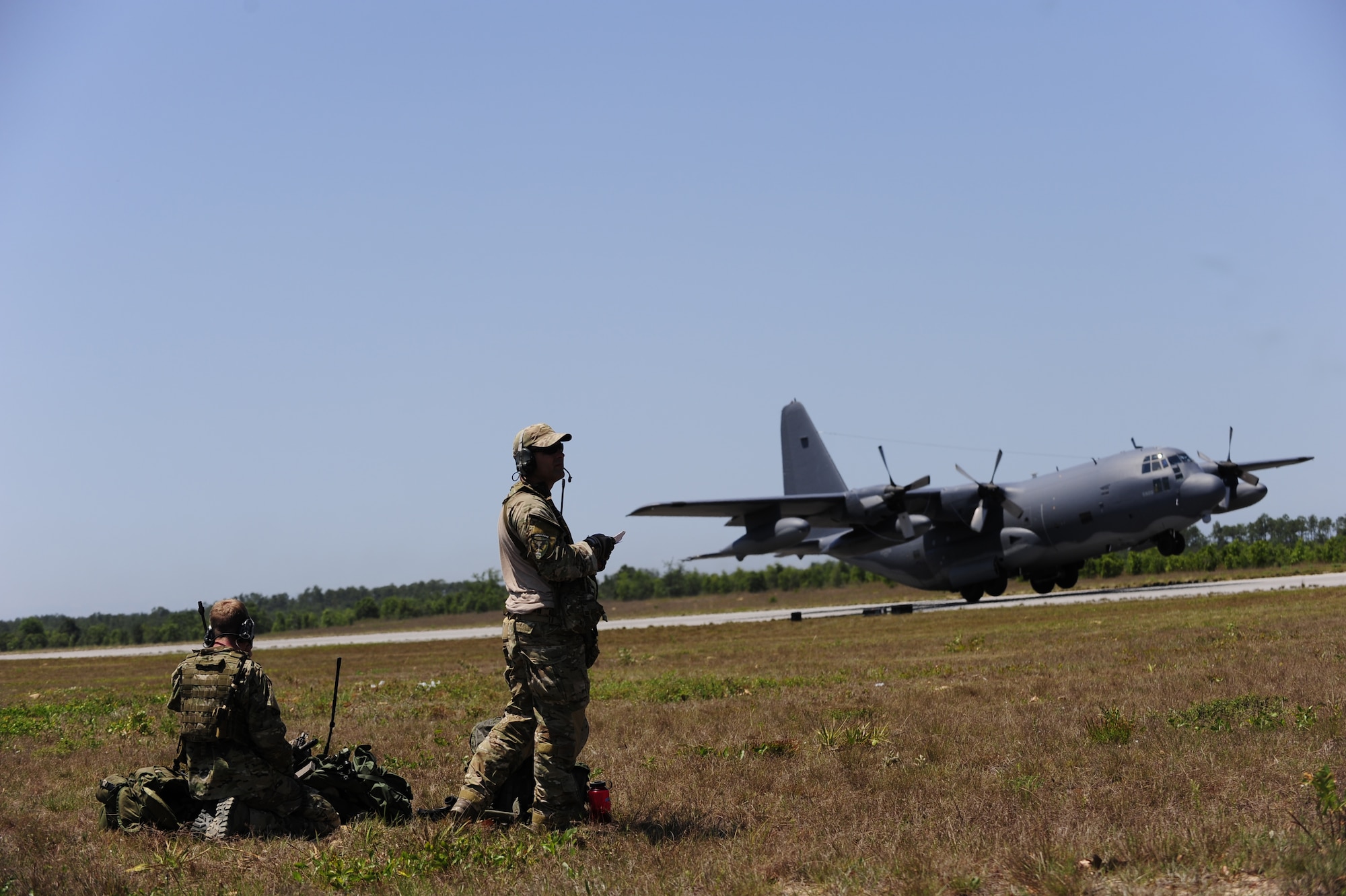 Combat controllers from the 21st Special Tactics Squadron, scan the runway as a 9th Special Operations Squadron MC-130P takes off, Field 6, Eglin Air Force Base range, Fla., May 11, 2011. Operation Nimble Response is an exercise to hone humanitarian and disaster relief efforts. Close to 50 personnel from Head Quarters Air Force Special Operations Command, 1st Special Operations Wing, and 280th Combat Communications Squadron, in coordination with USAID, worked together to improve disaster response. (U.S. Air Force photo by Staff Sgt. Julianne M. Showalter/Released)
