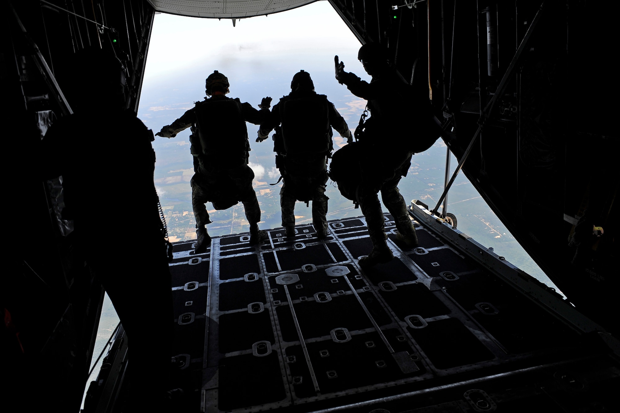 Special Operations Airmen jump off of a 9th Special Operations Squadron MC-130P platform to provide assistance to simulated ground forces, Field 6, Eglin Air Force Base range, Fla., May 11, 2011. Operation Nimble Response is an exercise to hone humanitarian and disaster relief efforts. Close to 50 personnel from Head Quarters Air Force Special Operations Command, 1st Special Operations Wing, and 280th Combat Communications Squadron, in coordination with USAID, worked together to improve disaster response. (U.S. Air Force photo by Staff Sgt. Julianne M. Showalter/Released)
